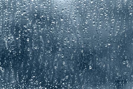 view through the raindrop window on rainy day