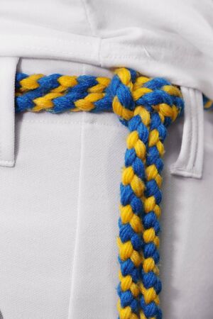 background of amarelo-azul capoeira cord  on the pants