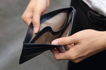 closeup on a businessman with empty wallet