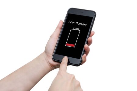 isolated hand using smart phone with low battery sign warning on the display screenの写真素材