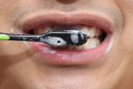 closeup on a man brushing his teeth