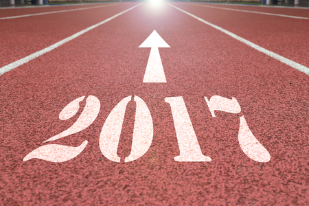 happy new year concept of background of running track in stadium with the arrow point to 2017