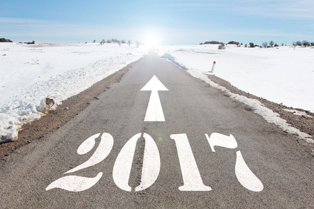 happy new year concept of snowy road heading to 2017