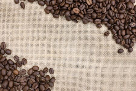 background of roasted coffee bean on a  burlap sackの写真素材