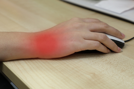 office syndrome concept of woman using mouse with wrist painの写真素材