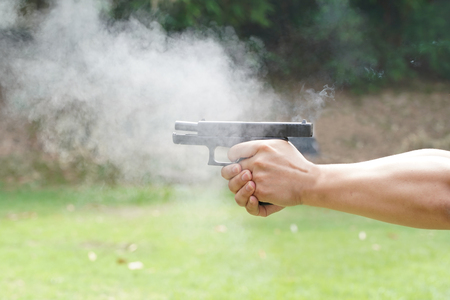 hand shooting with a pistolの写真素材
