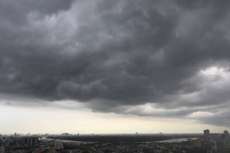 black clouds with thunder storm on the sky before raining over bangkok city