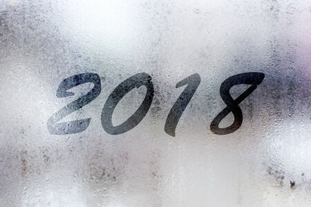 Happy New Year concept with foggy writting 2018 on the  mirror