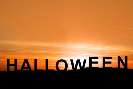 silhouette sunset view with words halloween on the mountainの写真素材