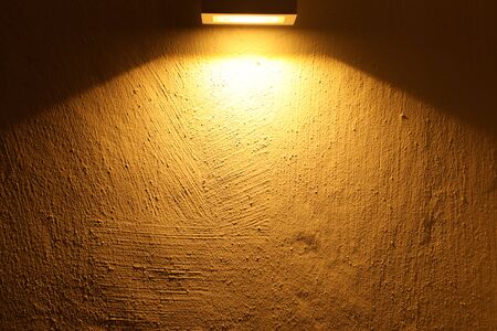 empty cement wall with yellow light with  blank copyspaceの写真素材