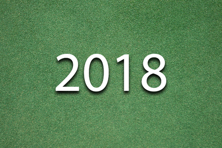 top view background of green grass field with 2018 new year conceptの写真素材