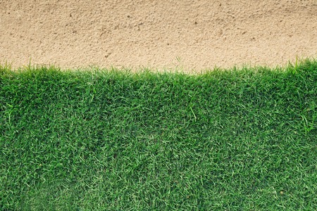 background of green grass with sand bunker in a golf courseの写真素材