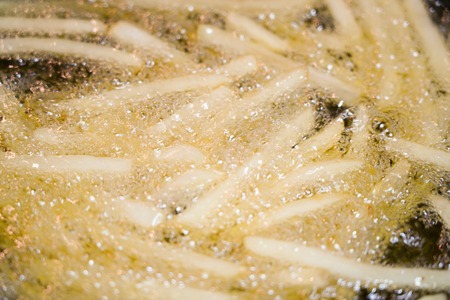French fried  frying in boiling oil on a panの写真素材