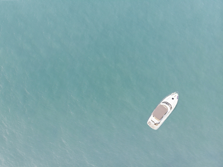 Aerial view of yacht on blue ocean with blank space
