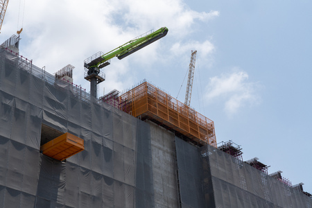 Construction site with the safety building net cover the building  against sky background