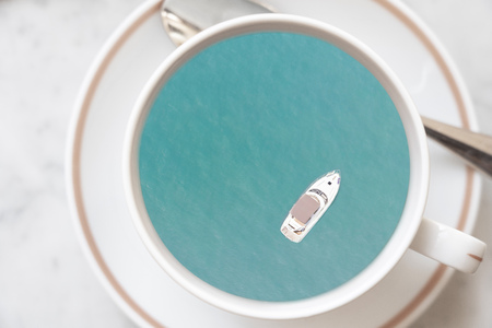 Yacht sailing in the sea in a cup of coffee for travel and relax conceptの写真素材
