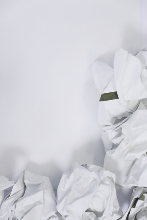 crumpled paper on white background with blank copyspaceの写真素材