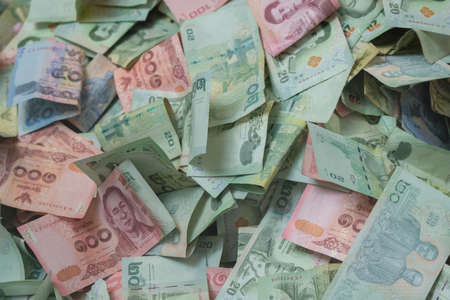 Background of Thai Baht Banknotes in a Donation Boxの写真素材