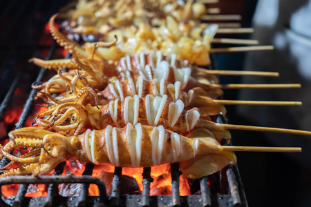 Grilled squid in a stick at the street food in china town thailandの写真素材