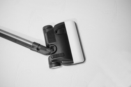 dust mite vacuum cleaner on the bedの写真素材