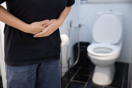 Woman touch her stomach with the symtom of diarrhea stomachache