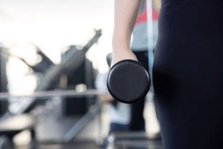 Close-Up on Woman Hand Holding Dumbell for her Exerciseの写真素材