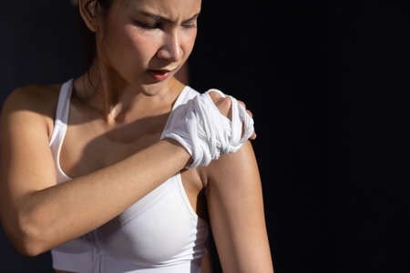 Asian Woman Grab His Shoulder With Pain with Shoulder Injured From Boxing Workoutの写真素材