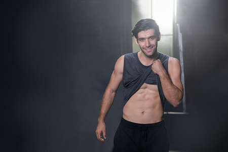 Portrait of a Man Standing Showing  His Abs Muscle at a Training Gymの写真素材