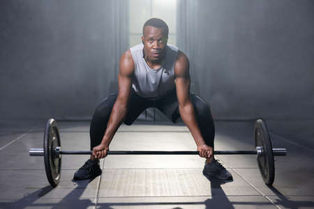 Black African American Man Holding Barbell Ready For Weight Lifting Workoutの写真素材