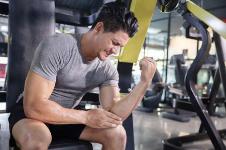 Caucasian Man Grab His Elbow with Pain by Elbow Injuredの写真素材