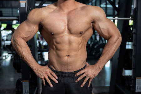 Close Up on Naked Male Bodybuilder Flexing His Muscleの写真素材