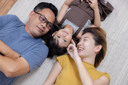 Top View of Happy Asian Family Lying on the Floor