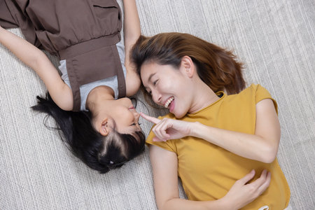 Top View of Happy Asian Family Lying on the Floorの写真素材