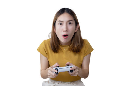Excited Asian Woman Play Console Game with a Game Controller on Sofaの写真素材