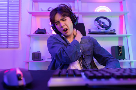 Asian Esport Gamer Grab His Shoulder Muscle with Pain After Playing Game For a Long Time