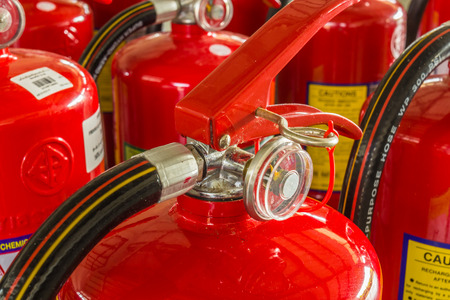 Red fire extinguishers available in fire emergencies の写真素材