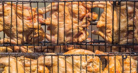 Grilled chicken at a time, using a steel bracket chicken.の写真素材