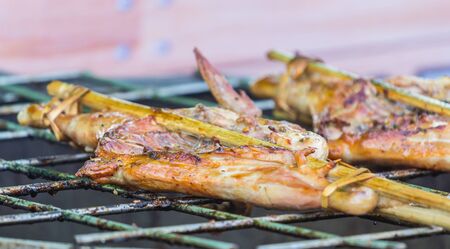 Grilled chicken at a time, using a steel bracket chicken.の写真素材