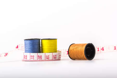 threads and tape measure on a white background.の写真素材