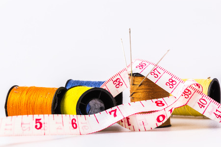 Needles in three of the lace into rolls sewing sewing thread with tape measure wrapped aroundの写真素材