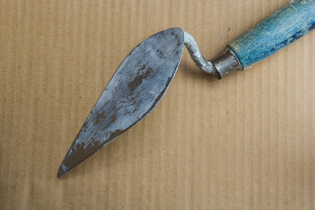 Trowel bricks used in construction workers. At long last, put on a brown background.の写真素材