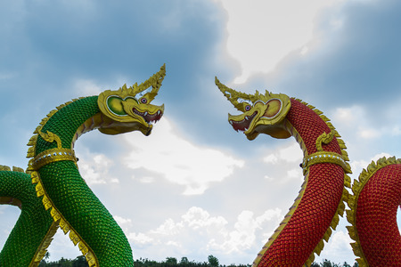 Naga second one looks green again look red. the face The background looks into the sky.
 This statue is located in public area.)の写真素材