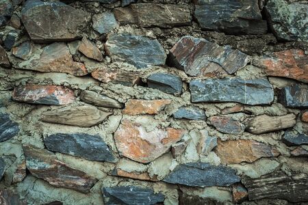 The stone was reduced to a smaller size for use in the construction of the wall. The colors of rocks of different causes beautiful.の写真素材