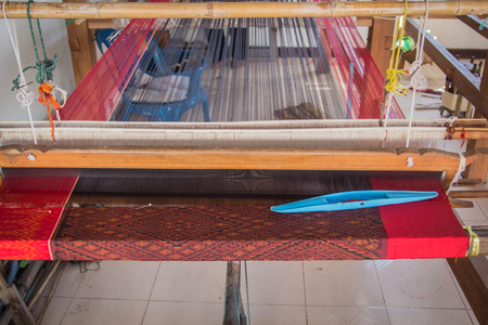 Loom made of plastic. The design of the home to put the thread used for weaving in Thailand.の写真素材