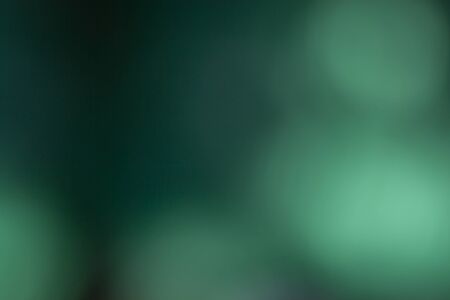 Green background, taken through a green filter in the light toward the sun, adjusting the image to be blurred.の写真素材