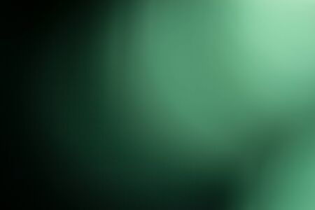 Green background, taken through a green filter in the light toward the sun, adjusting the image to be blurred with the white edges of the image.の写真素材