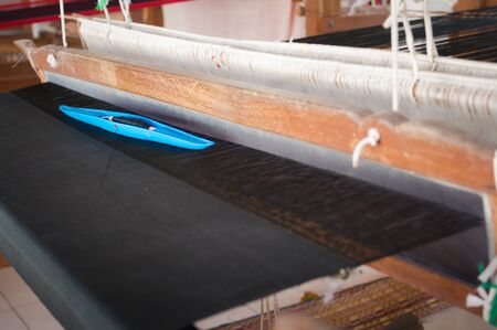 Loom made of plastic. The design of the home to put the thread used for weaving in Thailand.の写真素材