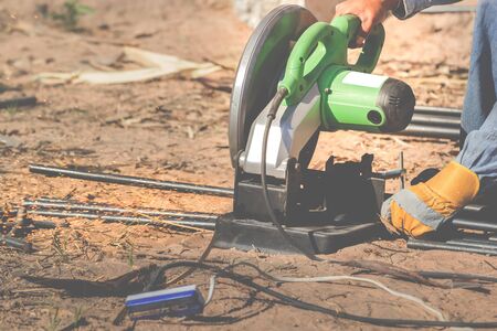 The electric iron cutter cut the iron on the ground.の写真素材