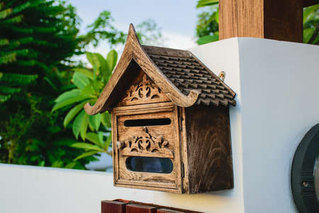 Decorated wooden mailbox with screw bolts supportの写真素材