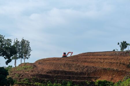 A small excavator earthmoving works on  construction site.